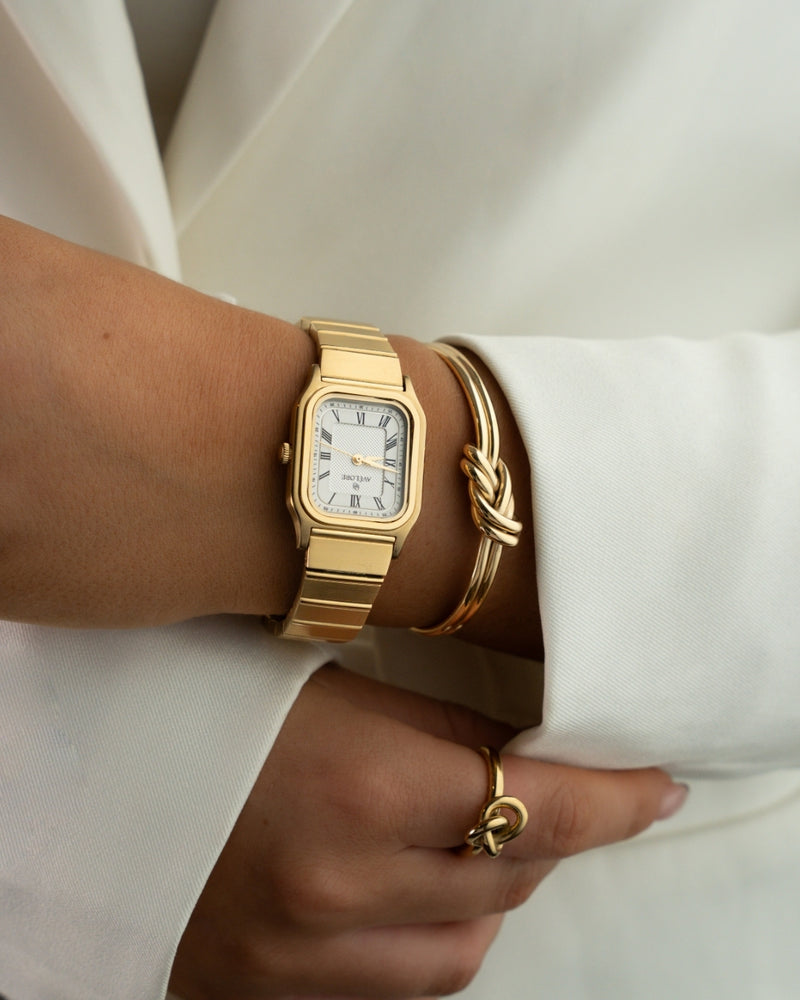 Gold square watch for women with white dial and gold band. The model is Aima by Avelore.