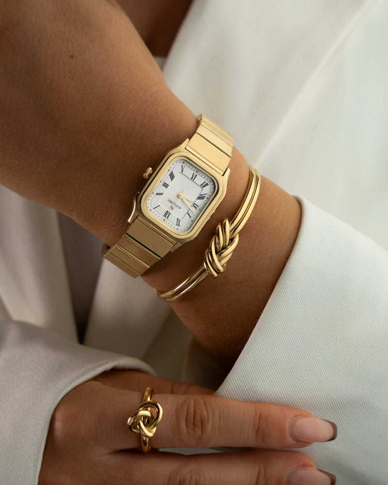 Gold square watch for women with white dial and gold band. The model is Aima by Avelore.