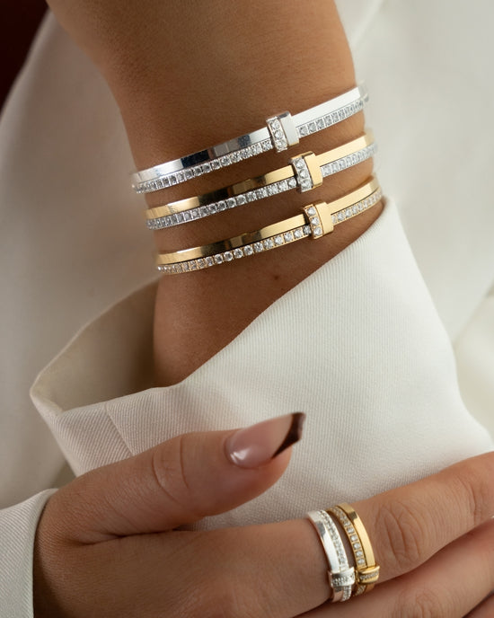Gold bracelet with diamond accents on a white background. The model is Ame bangle by Avelore Women's Bracelets