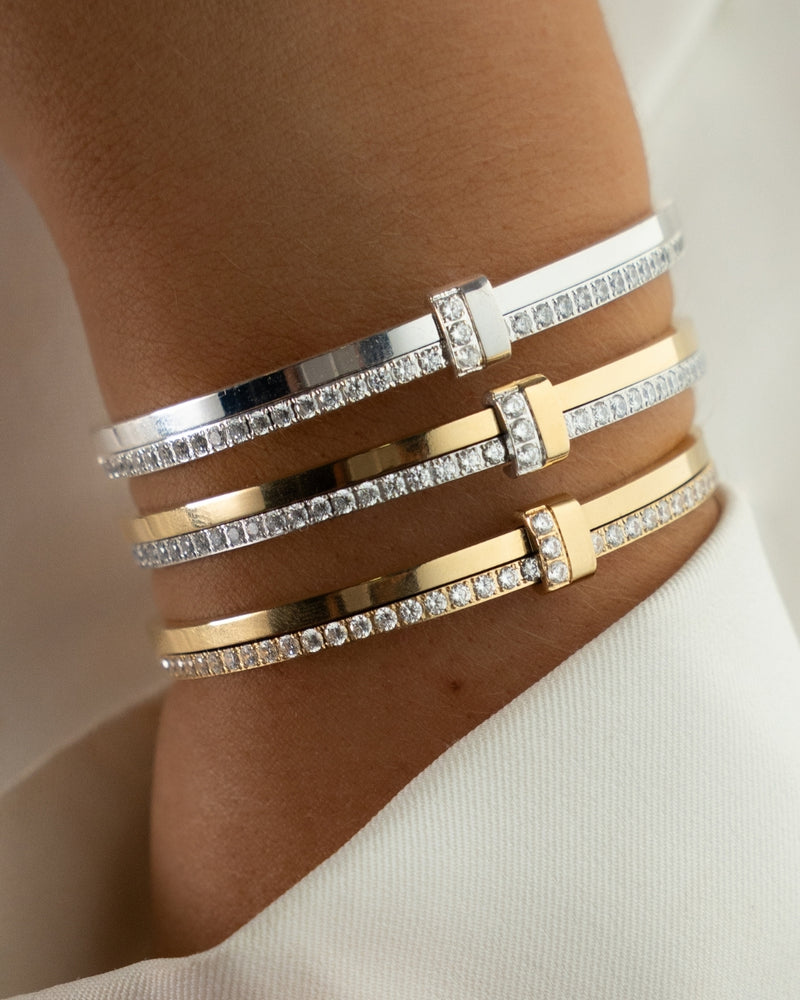 Gold bracelet with diamond accents on a white background. The model is Ame bangle by Avelore Women's Bracelets