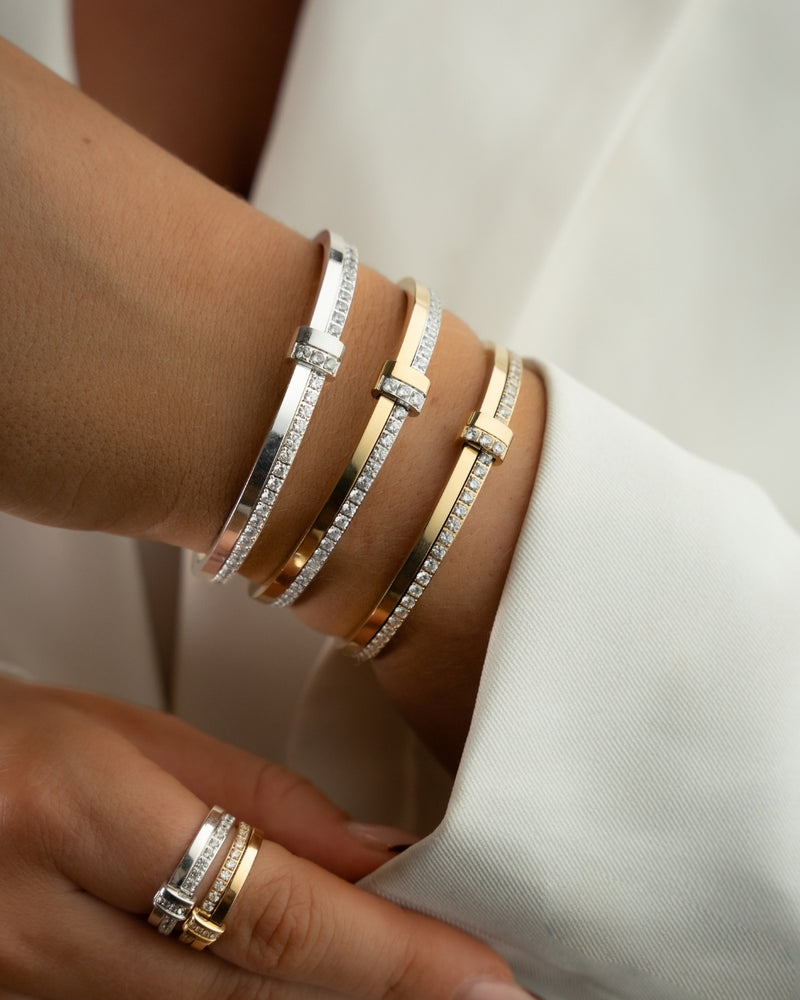 Gold bracelet with diamond accents on a white background. The model is Ame bangle by Avelore Women's Bracelets