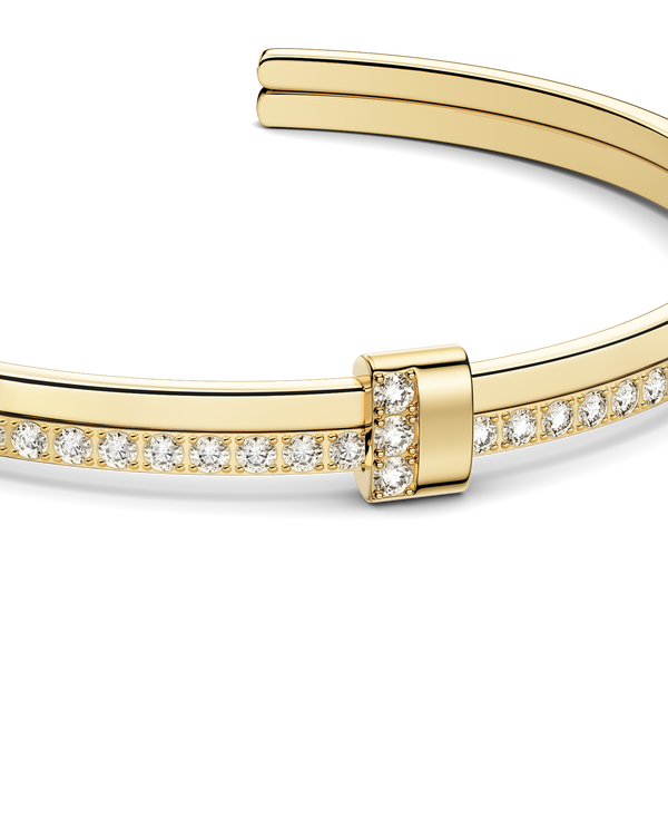 Gold bracelet with diamond accents on a white background. The model is Ame bangle by Avelore Women's Bracelets