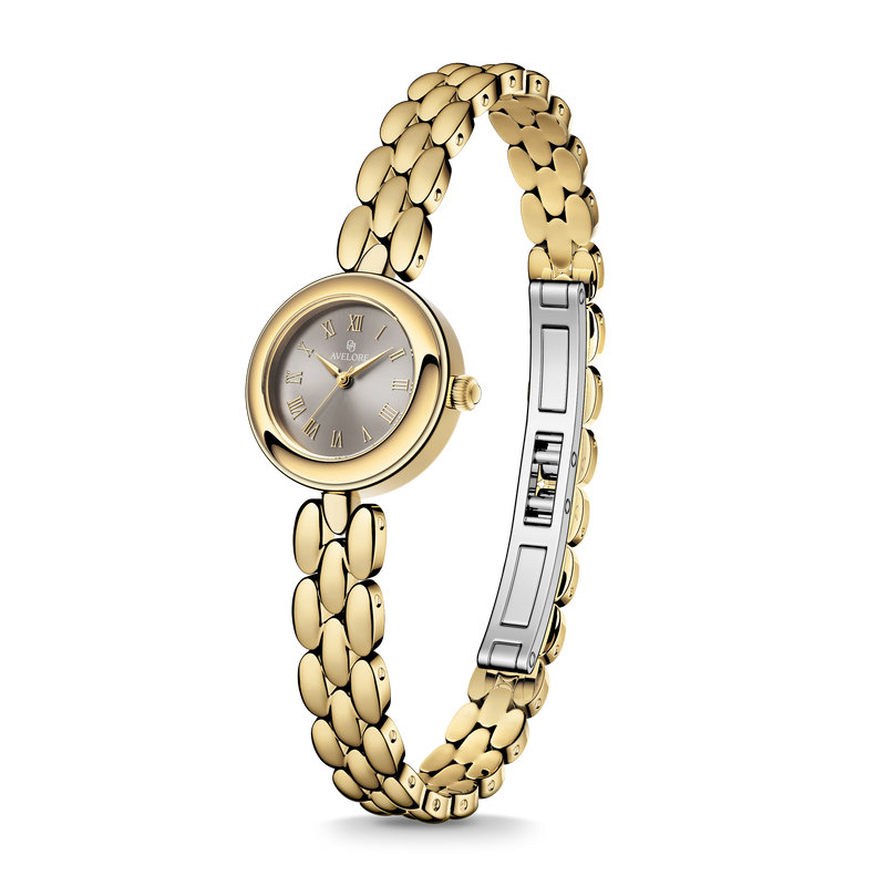 Gold round small watch for women with brown dial and gold band. The model is Eira by Avelore.