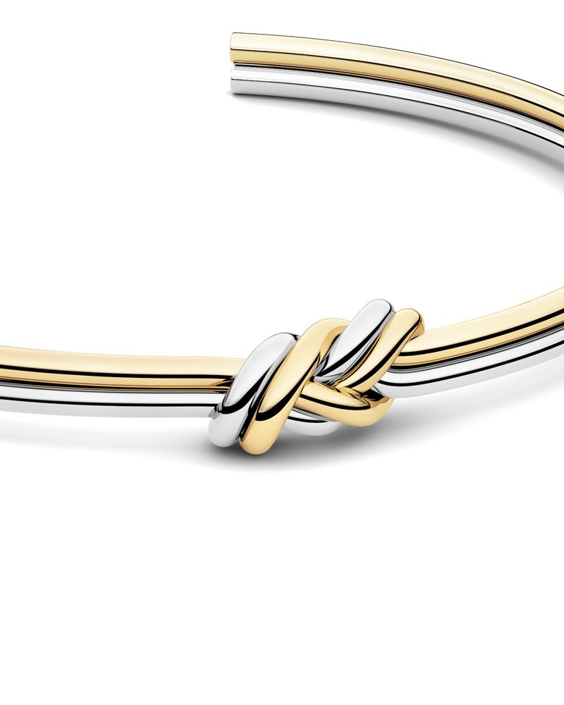 Two-toned bracelet with triple knot detail. The model is Naia bangle by Avelore Women's Bracelets