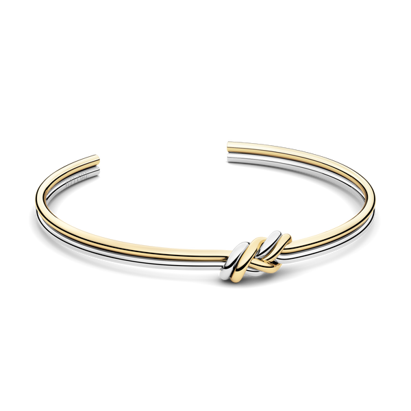 Two-toned bracelet with triple knot detail. The model is Naia bangle by Avelore Women's Bracelets