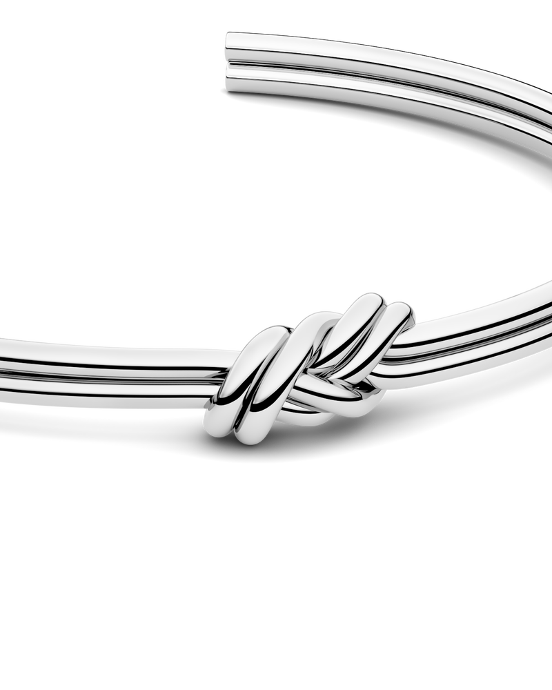 Silver bracelet with triple knot detail. The model is Naia bangle by Avelore Women's Bracelets