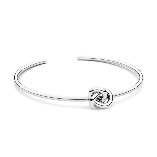 Silver bracelet with a knot design. The model is Veda Bangle by Avelore. Women's Bracelets