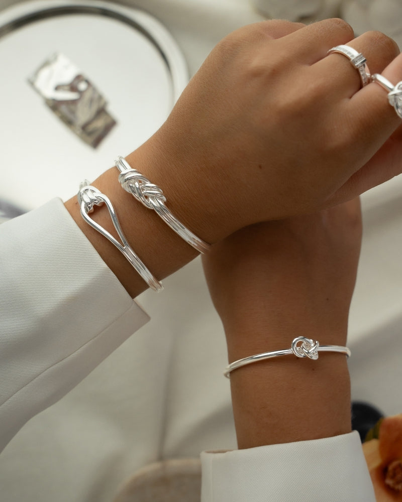 Silver bracelet with loop knot detail. The model is Coce bangle by Avelore Women's Bracelets