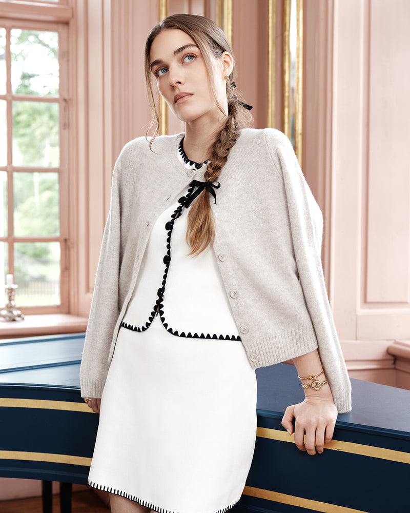 Gold round small watch for women with brown dial and gold band. The model is Eira by Avelore.