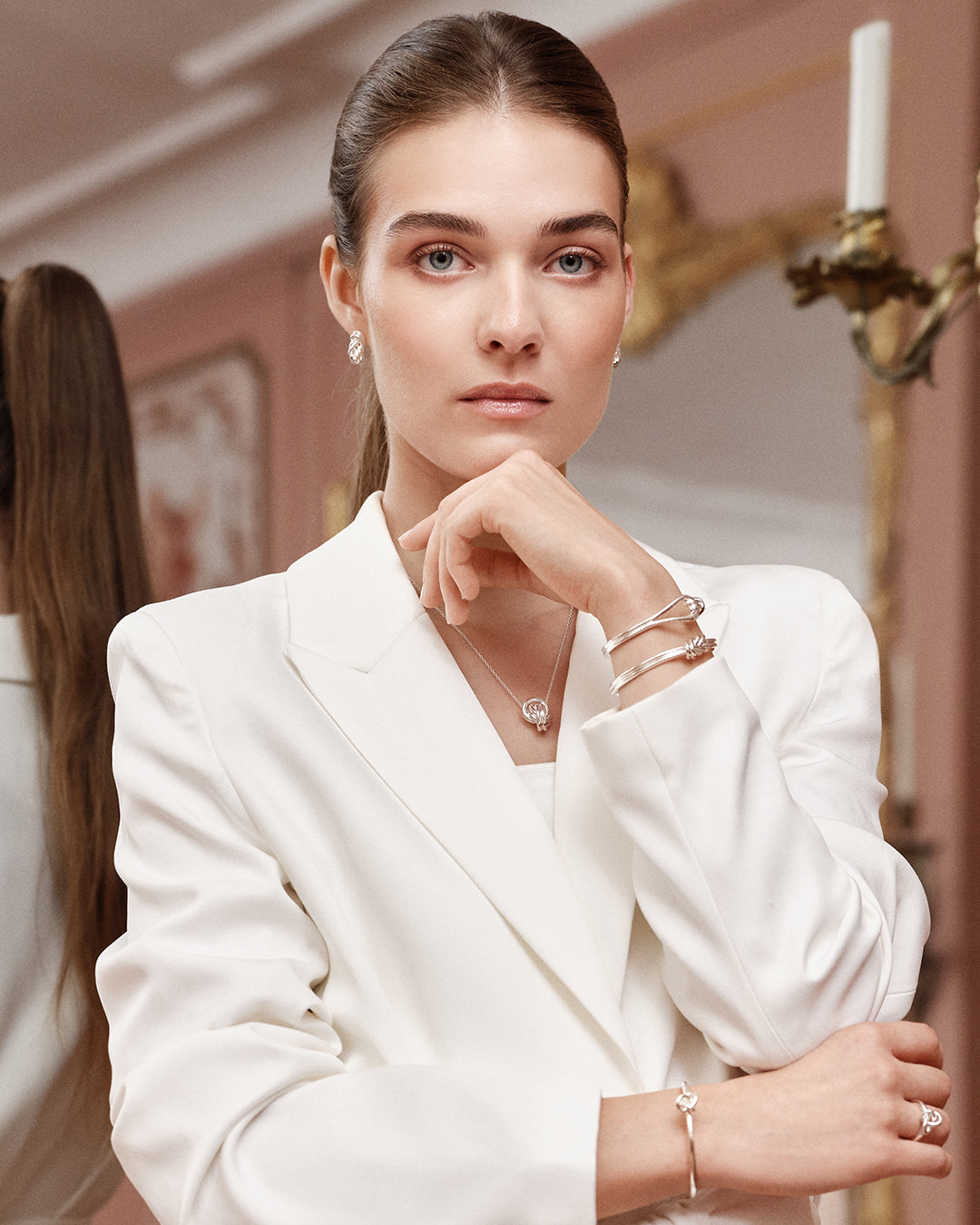 Silver bracelet with triple knot detail. The model is Naia bangle by Avelore Women's Bracelets