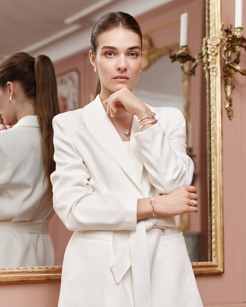 Silver bracelet with triple knot detail. The model is Naia bangle by Avelore Women's Bracelets