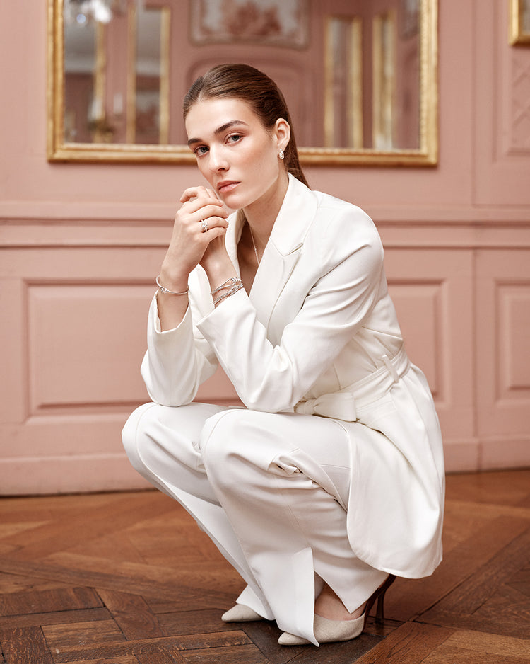 Silver bracelet with triple knot detail. The model is Naia bangle by Avelore Women's Bracelets