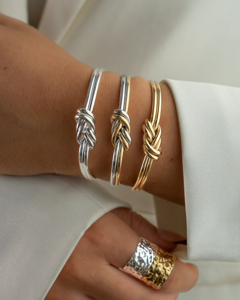 Two-toned bracelet with triple knot detail. The model is Naia bangle by Avelore Women's Bracelets