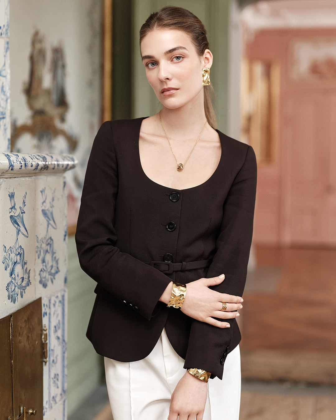 Gold jewelry set earring with hammered surface details. The model is Noem by Avelore Women's jewelry.
