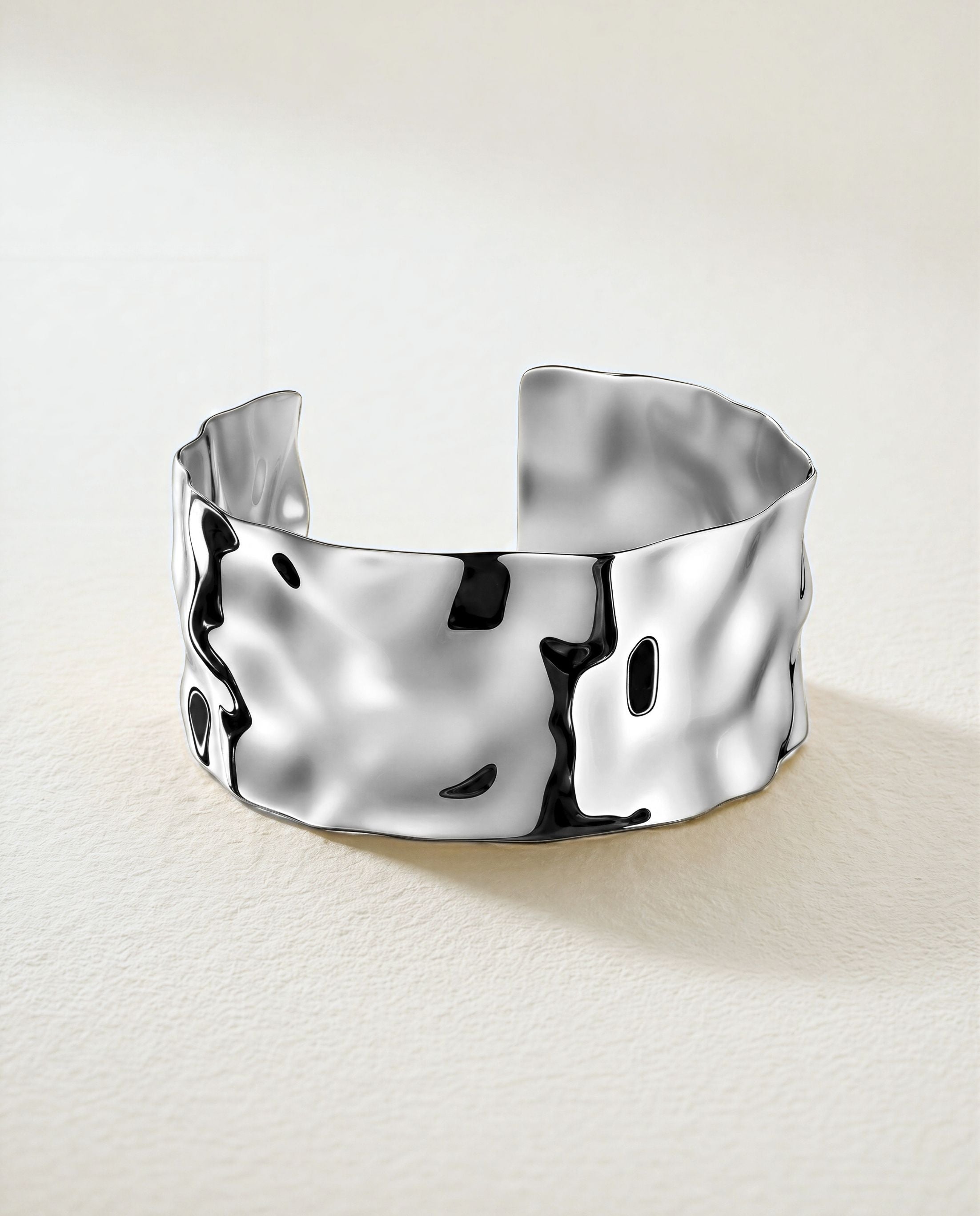 Wide Cuff Bracelet in silver with hammered surface. The model is Noem Bangle by Avelore.