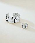 Wide Cuff Bracelet in silver with hammered surface. The model is Noem Bangle by Avelore.