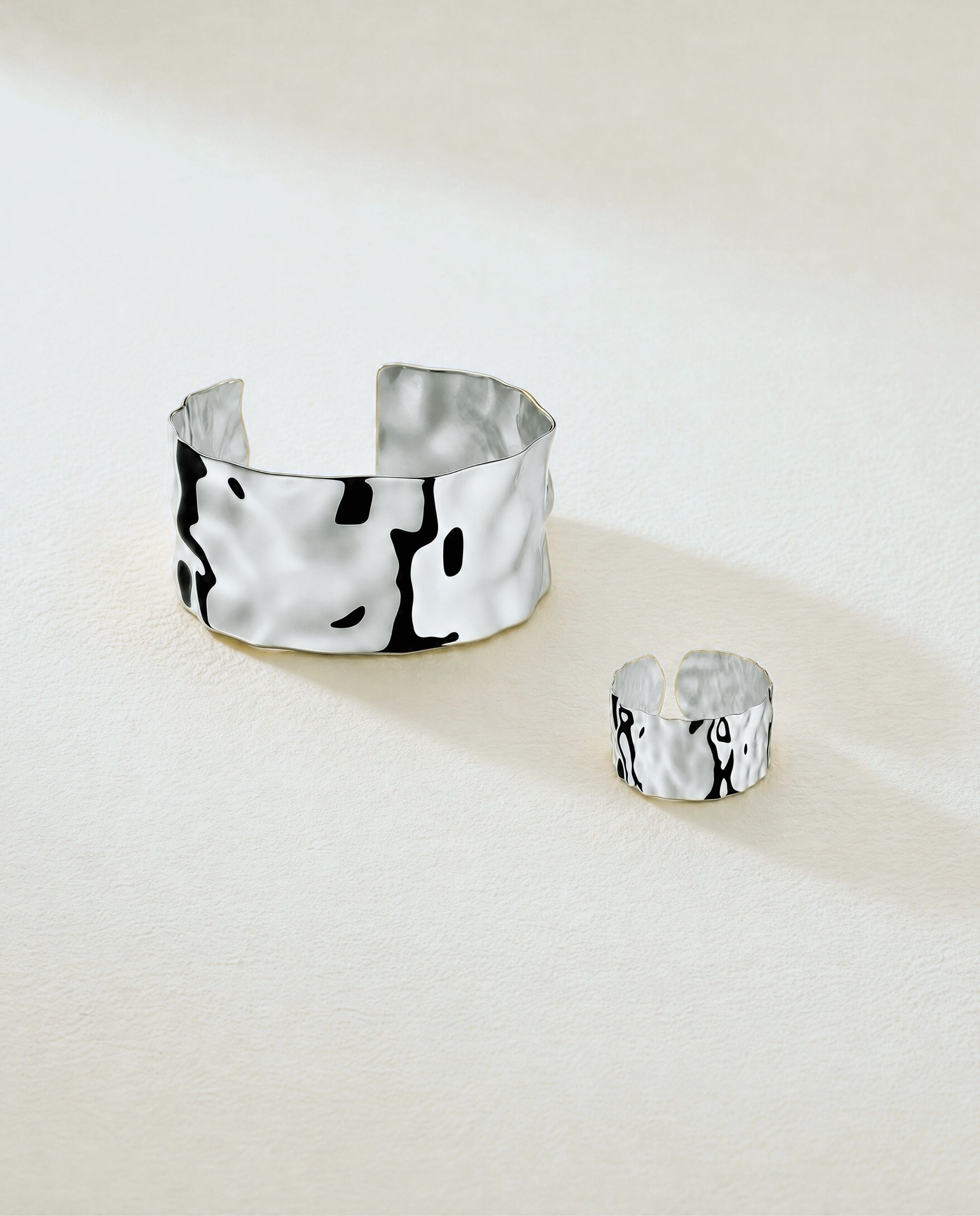 Wide Cuff Bracelet in silver with hammered surface. The model is Noem Bangle by Avelore.