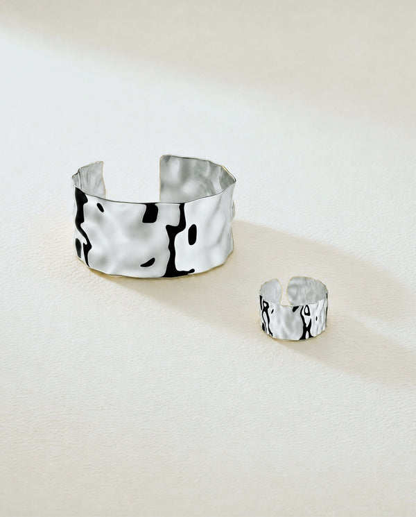Wide Cuff Bracelet in silver with hammered surface. The model is Noem Bangle by Avelore.