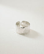 Wide Cuff Ring in silver with hammered surface. The model is Noem Bangle by Avelore.