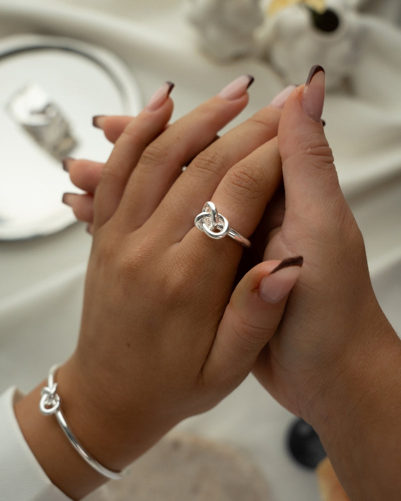 Silver knot ring by Avelore. The model is Veda Ring. Women's Rings.