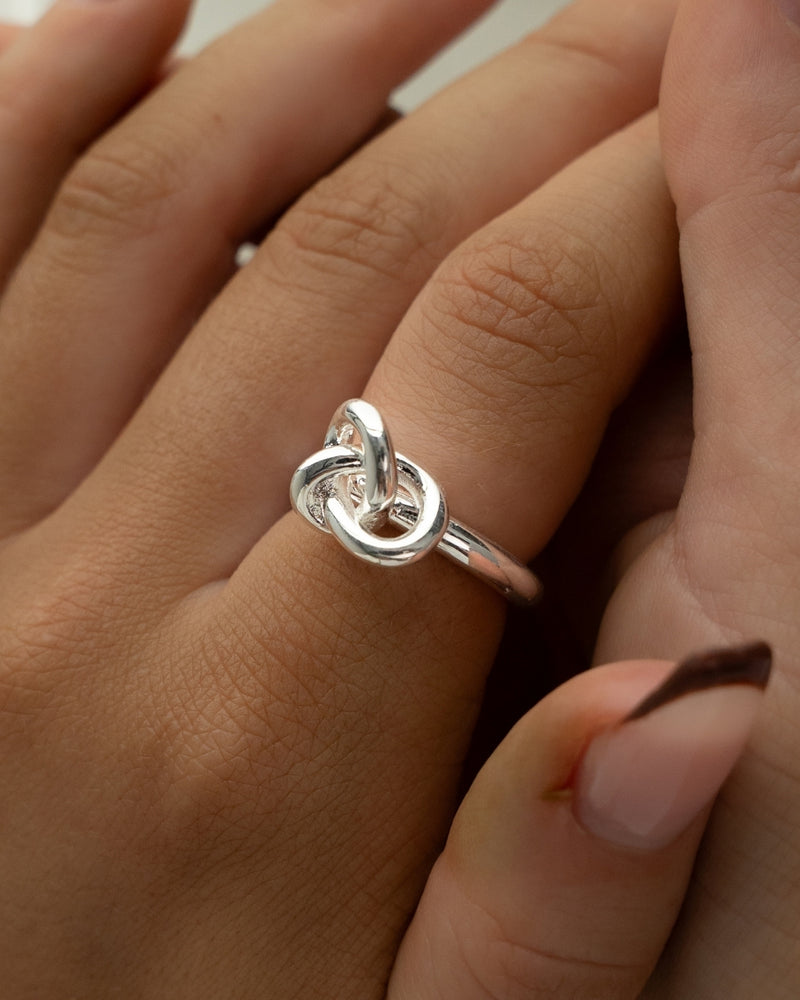 Silver knot ring by Avelore. The model is Veda Ring. Women's Rings.