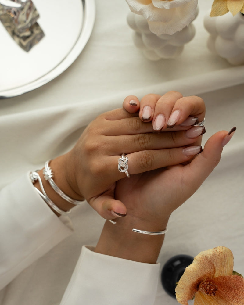 Silver knot ring by Avelore. The model is Veda Ring. Women's Rings.